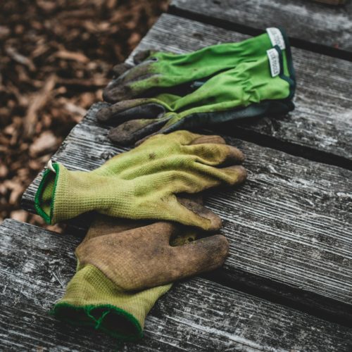 brown and green sock on gray wooden surface