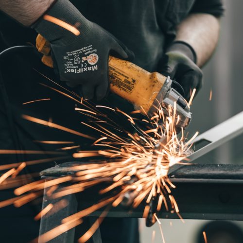 a man using a grinder on a piece of metal